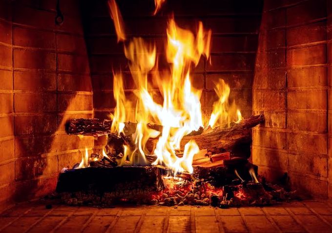 Strong fire burning inside a clean brick firebox